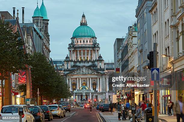 facade of the belfast city hall at dusk - belfast stock-fotos und bilder