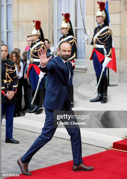 France's newly-appointed Prime Minister Edouard Philippe waves after an official handover ceremony with outgoing Prime Minister Bernard Cazeneuve at...