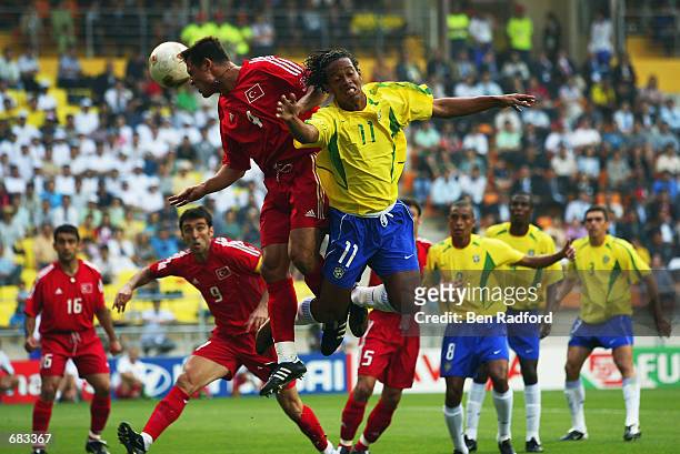 Fatih Akyel of Turkey wins a header from Ronaldinho of Brazil during the Group C match of the World Cup Group Stage played at the Ulsan-Munsu World...