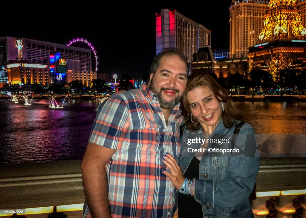 A couple posing in front of Las Vegas Strip