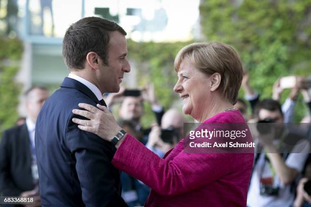 German Chancellor Angela Merkel and newly-elected French President Emmanuel Macron chat upon Macron's arrival at the Chancellery on May 15, 2017 in...