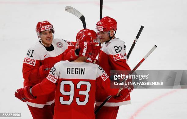 Denmark´s players celebrate scoring during the IIHF Men's World Championship Ice Hockey match between Denmark and Italy in Cologne, western Germany,...