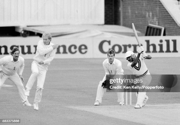 Pakistan batsman Javed Miandad drives the ball through the off-side, prompting England fielder David Gower to take evasive action during the 1st Test...