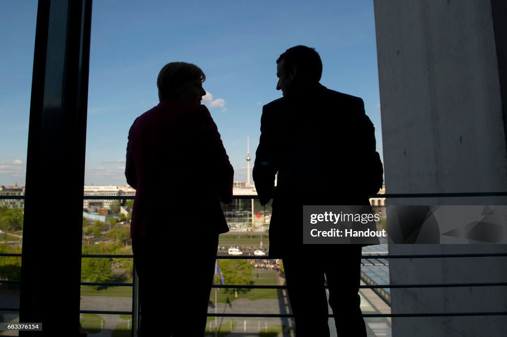 French President Emmanuel Macron Meets Angela Merkel In Berlin