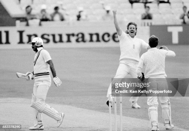 England bowler Ian Botham celebrates the wicket of Pakistan batsman Javed Miandad, caught by England wicketkeeper Bruce French for 21, during the 1st...