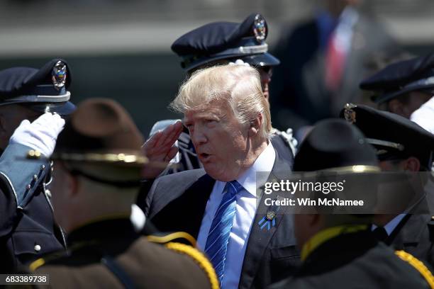 President Donald Trump salutes police officers as he arrives at the 36th annual National Peace Officers' Memorial Service at the U.S. Capitol on May...