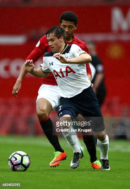 Filip Lesniak of Tottenham Hotspur battles with Devonte Redmond of Manchester United during the Premier League 2 match between Manchester United and...