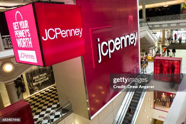 Signage is displayed at the entrance of a JC Penney department store inside the Manhattan Mall, May 15, 2017 in the Herald Square neighborhood in New...