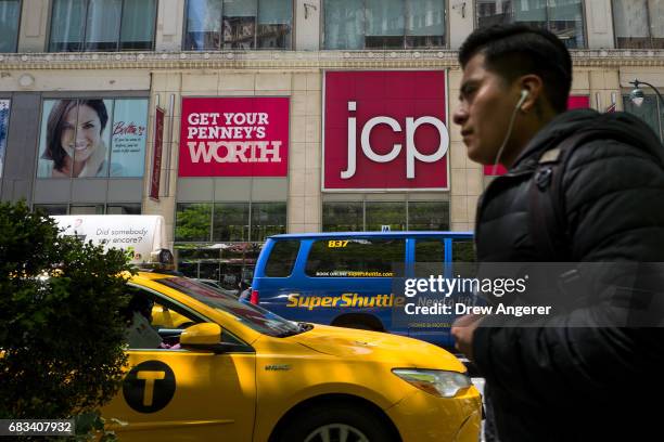 Man walks past signage for a JC Penney department store, May 15, 2017 in the Herald Square neighborhood in New York City. Shares of the struggling...
