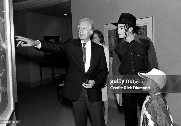 Former President Jimmy Carter gives Michael Jackson and Emmanuel Lewis a tour of his office at The Carter Center both Jackson and Lewis are in...