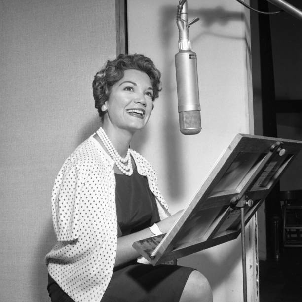 Entertainer Connie Francis records in the studio with producer Ray Ellis at MGM on July 10, 1959 in New York.