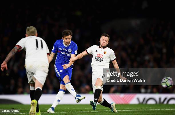 Cesc Fabregas of Chelsea scores his sides fourth goal as Tom Cleverley of Watford attempts to block during the Premier League match between Chelsea...