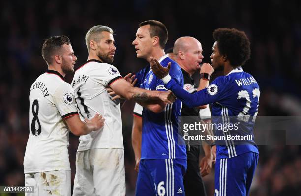 Tom Cleverley of Watford and Valon Behrami of Watford clash with John Terry of Chelsea and Willian of Chelsea during the Premier League match between...