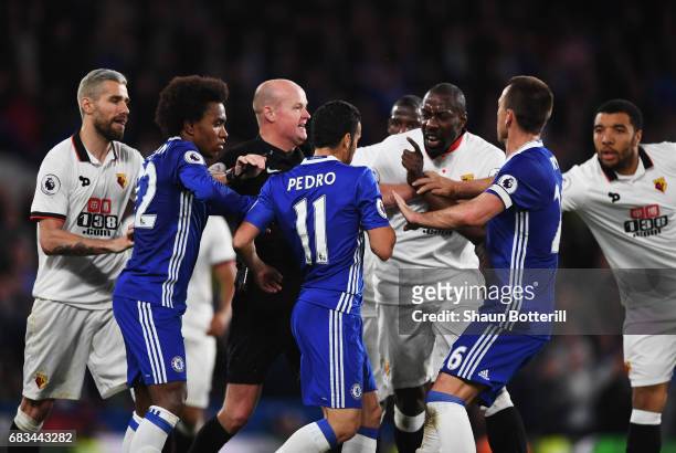 Referee Lee Mason attempts to stop Pedro of Chelsea and Stefano Okaka of Watford from clashing during the Premier League match between Chelsea and...