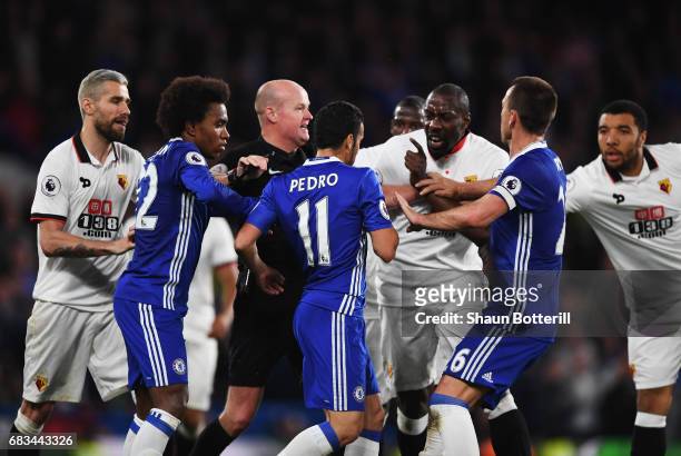 Referee Lee Mason attempts to stop Pedro of Chelsea and Stefano Okaka of Watford from clashing during the Premier League match between Chelsea and...