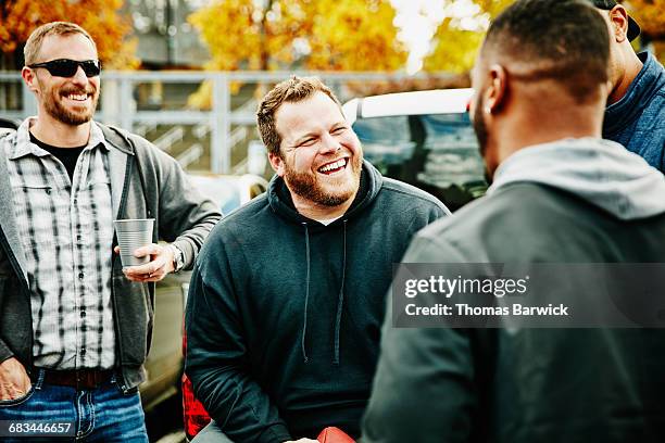 friends hanging out during tailgating party - small group of people outside stock pictures, royalty-free photos & images