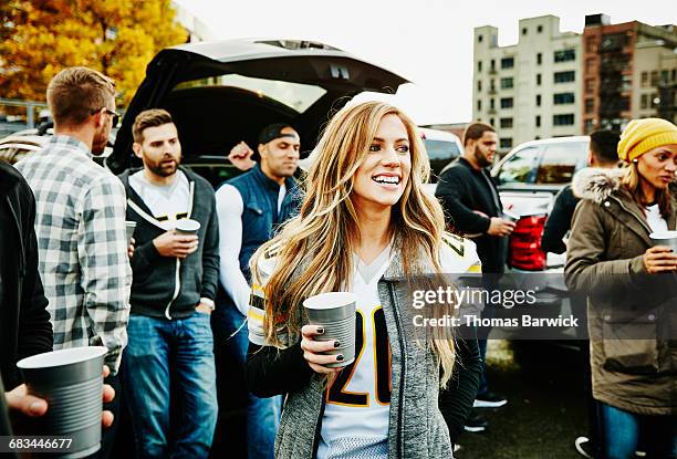 woman hanging out with friends at tailgating party - tailgate stock pictures, royalty-free photos & images
