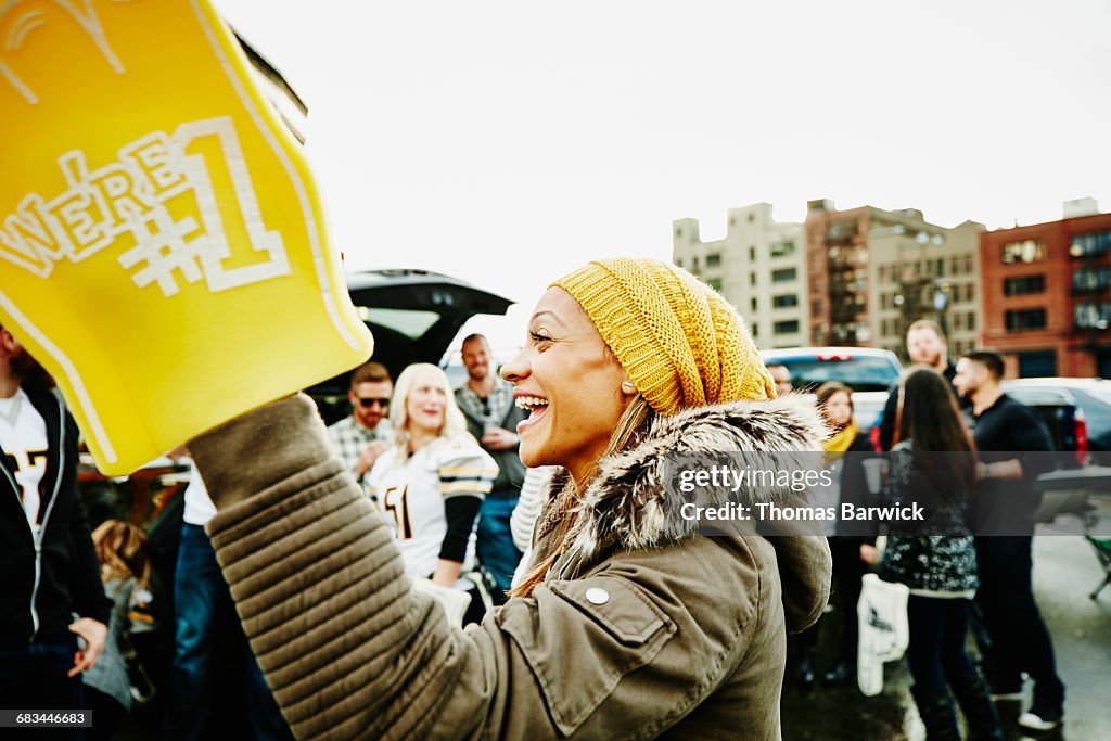 Woman with foam finger celebrating with friends