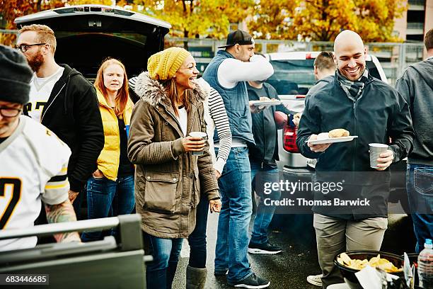 laughing friends at tailgating party - united party stock pictures, royalty-free photos & images