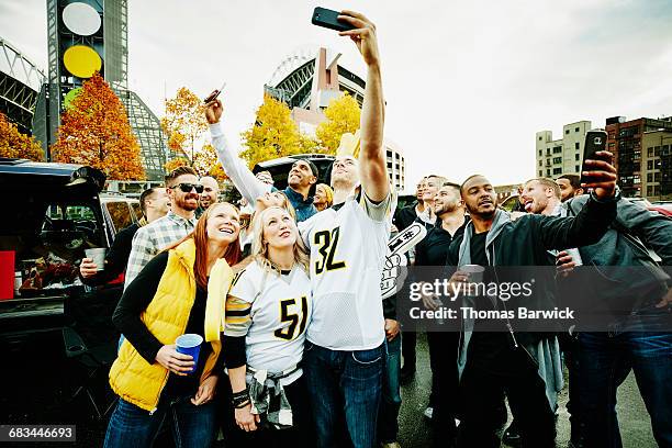 friends taking selfies at tailgating party - tailgating stock pictures, royalty-free photos & images