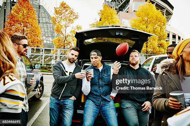 friends toasting at tailgating party before game - masculinidade imagens e fotografias de stock