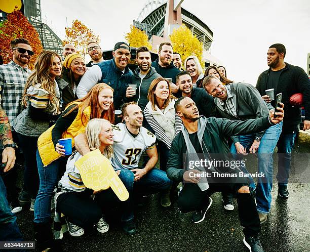 group of friends taking selfie at tailgating party - straatfeest stockfoto's en -beelden