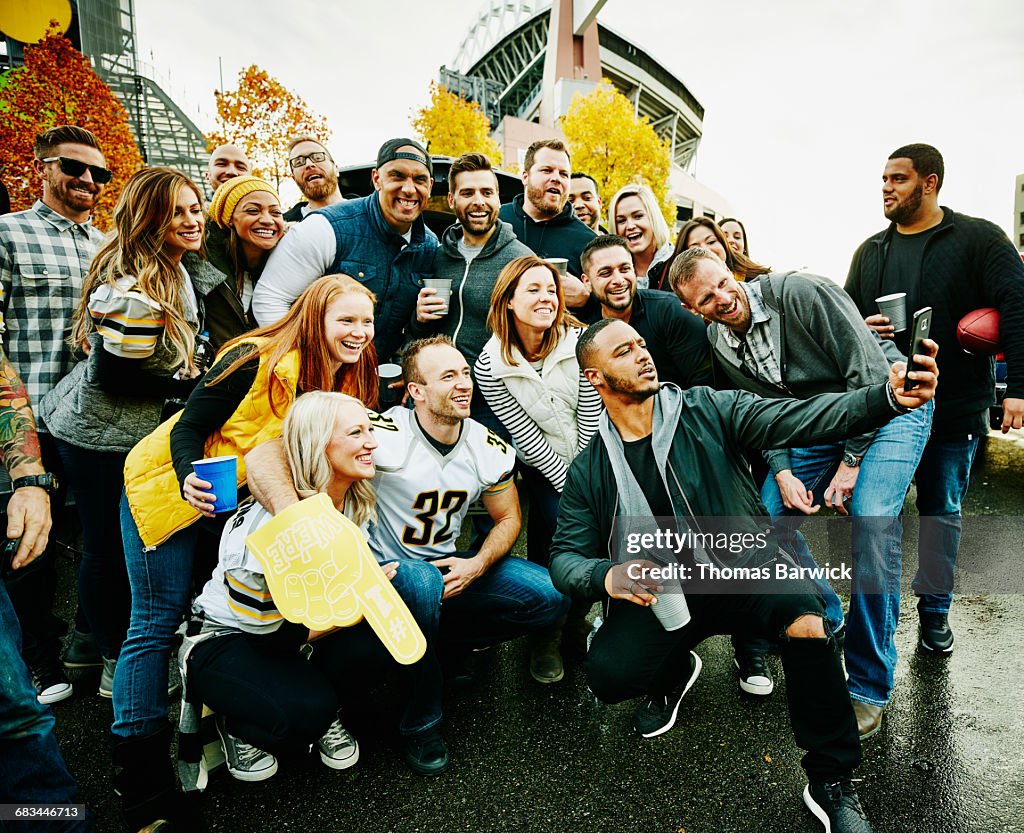 Group of friends taking selfie at tailgating party
