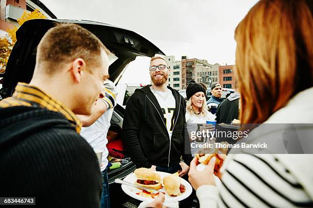 friends eating and drinking at tailgating party - 30 39 years stock pictures, royalty-free photos & images