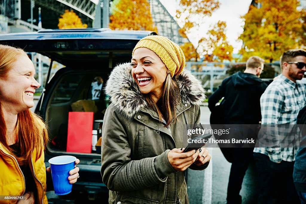 Laughing friends at tailgating party