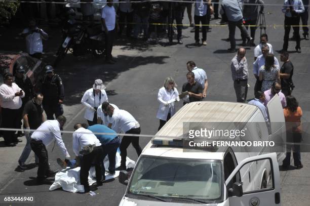 The body of Mexican journalist Javier Valdez is put on a stretcher by forensic personnel and investigators after he was shot dead in Culiacan,...