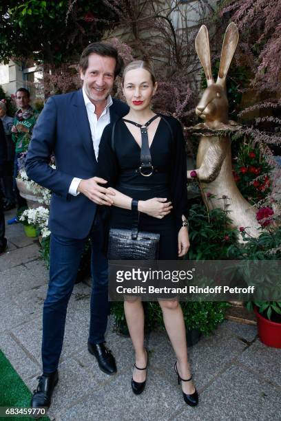 Carlos Ferre and Melonie Foster Hennessy attend the "The Garden of Peter Marino" Book Signing at "Moulie Flowers" on May 15, 2017 in Paris, France....