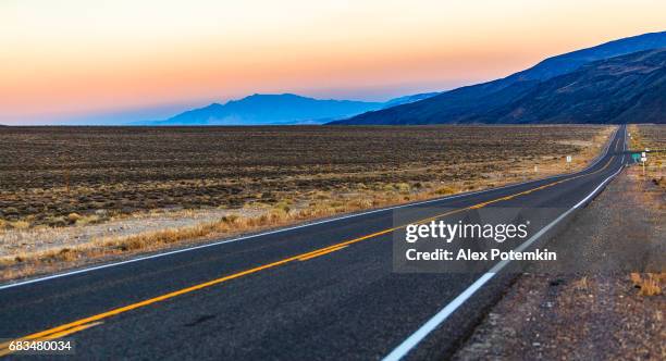 the desert highway in nevada at sunset - nevada road stock pictures, royalty-free photos & images