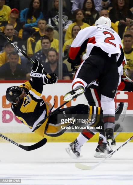 Dion Phaneuf of the Ottawa Senators hits Bryan Rust of the Pittsburgh Penguins during the first period in Game Two of the Eastern Conference Final...