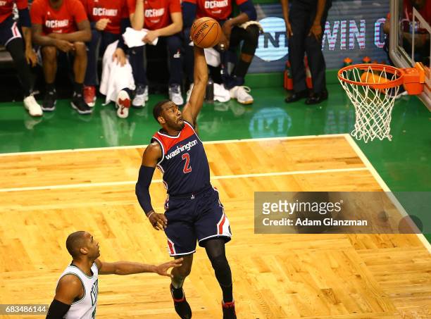 John Wall of the Washington Wizards dunks against Al Horford of the Boston Celtics during Game Seven of the NBA Eastern Conference Semi-Finals at TD...