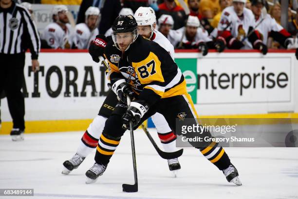 Sidney Crosby of the Pittsburgh Penguins skates up ice in front of Clarke MacArthur of the Ottawa Senators in Game One of the Eastern Conference...