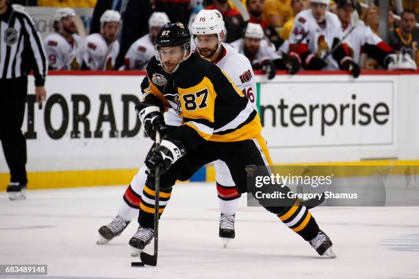 Sidney Crosby of the Pittsburgh Penguins skates up ice in front of Clarke MacArthur of the Ottawa Senators in Game One of the Eastern Conference...