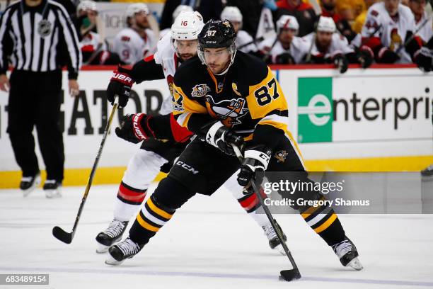 Sidney Crosby of the Pittsburgh Penguins skates up ice in front of Clarke MacArthur of the Ottawa Senators in Game One of the Eastern Conference...