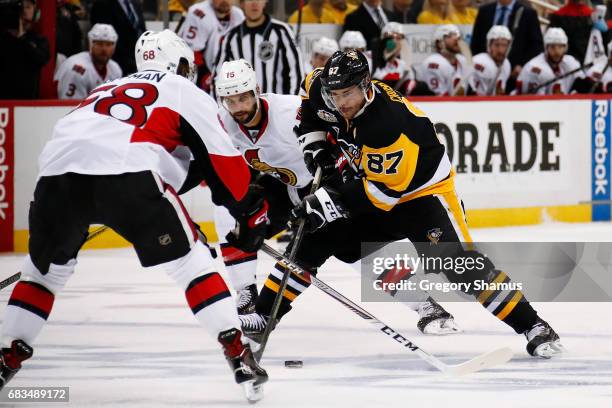 Sidney Crosby of the Pittsburgh Penguins skates up ice in front of Clarke MacArthur of the Ottawa Senators in Game One of the Eastern Conference...