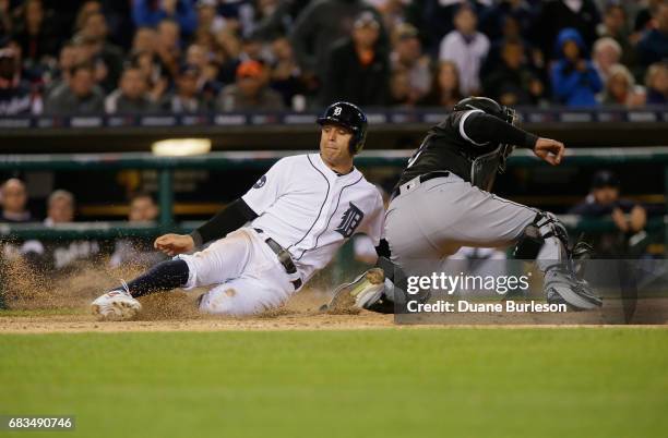 Ian Kinsler of the Detroit Tigers scores against Geovany Soto of the Chicago White Sox on a single by Victor Martinez during the fifth inning at...