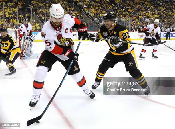 Sidney Crosby of the Pittsburgh Penguins checks Erik Karlsson of the Ottawa Senators during the second period in Game Two of the Eastern Conference...