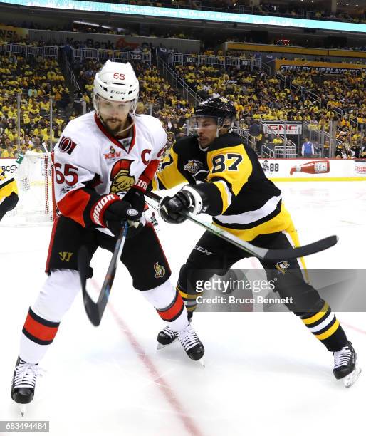 Sidney Crosby of the Pittsburgh Penguins checks Erik Karlsson of the Ottawa Senators during the second period in Game Two of the Eastern Conference...