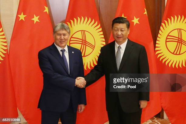 Kyrgyzstan President Almazbek Sharshenovich Atambayev , shakes hands with Chinese President Xi Jinping ahead a bilateral meeting at Diaoyutai State...