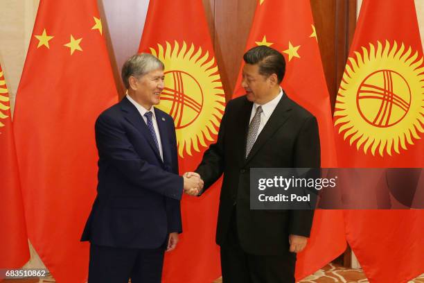 Kyrgyzstan President Almazbek Sharshenovich Atambayev , shakes hands with Chinese President Xi Jinping ahead a bilateral meeting at Diaoyutai State...