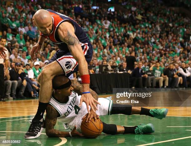 Isaiah Thomas of the Boston Celtics battles for the ball under Marcin Gortat of the Washington Wizards during Game Seven of the NBA Eastern...