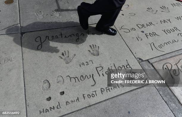 Legendary Hollywood actress Mary Pickford added an arrow imprint to the cement during her 1927 Hand and Foot print ceremony in front of the TCL...