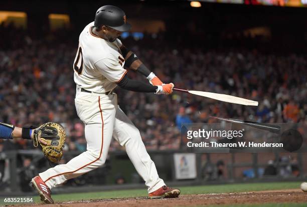 Eduardo Nunez of the San Francisco Giants breaks his bat hitting an rbi single to score Buster Posey against the Los Angeles Dodgers in the bottom of...