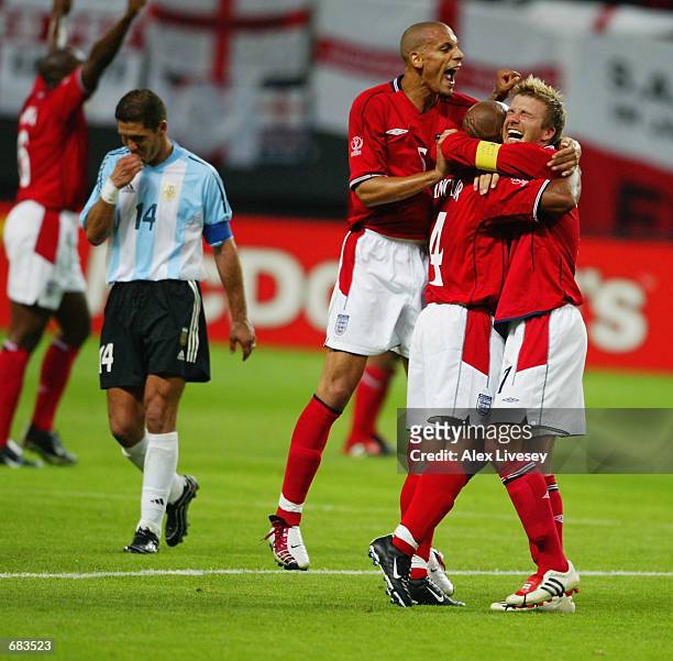 David Beckham of England celebrates with team mates Rio Ferdinand and Trevor Sinclair after winning the England v Argentina, Group F, World Cup Group...