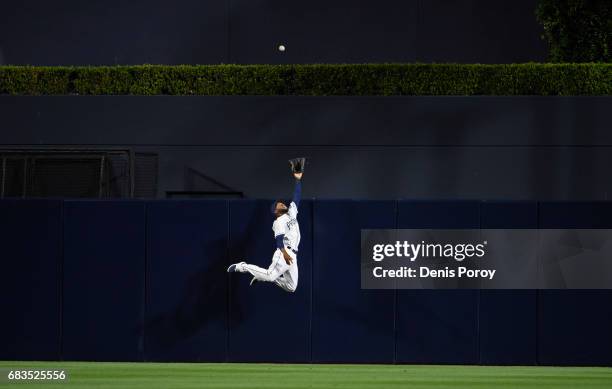 Manuel Margot of the San Diego Padres jumps but can't make the catch on solo home run off the bat of Jesus Aguilar of the Milwaukee Brewers during...