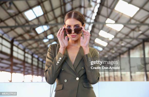 Erin Holland wearing Farage tuxedo, Christian Louboutinshoes, sungalsses Mimi and Mimco bag during Mercedes-Benz Fashion Week Resort 18 Collections...