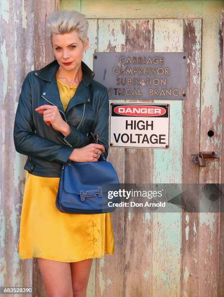 Kate Peck wearing Hansen and Gretel dress and jacket, shoes from Midas, boots from Midas, bag from Tod's, and sunglasses from Local Supply during...